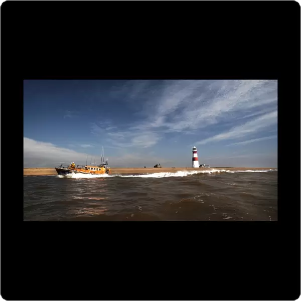 Aldeburgh mersey class lifeboat Freddie Cooper 12-34 moving from right to left, lighthouse in the background