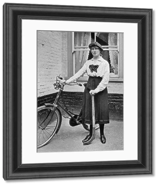 Young woman with bicycle and hockey stick
