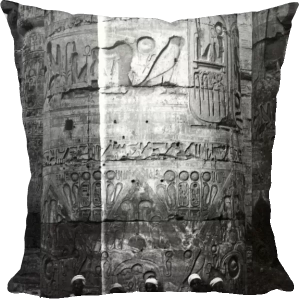 Men sitting at base of column, Karnak, Egypt