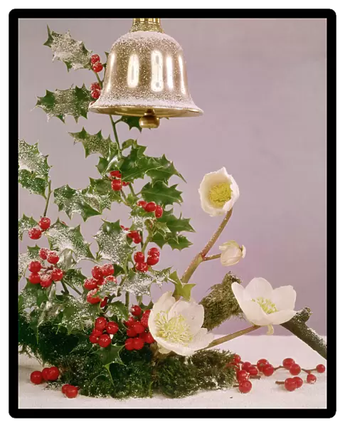 Christmas arrangement of holly, flowers and bell