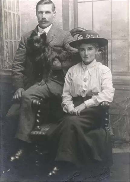 Studio portrait, couple with dog