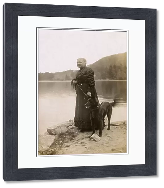 Woman with a dog by a lake, Vosges, France