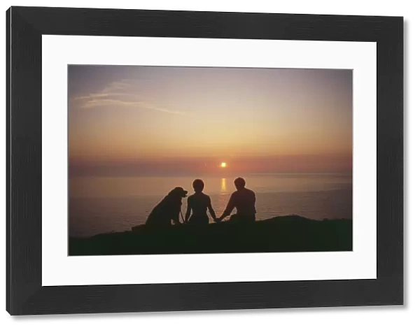 West Country sunset with couple and dog