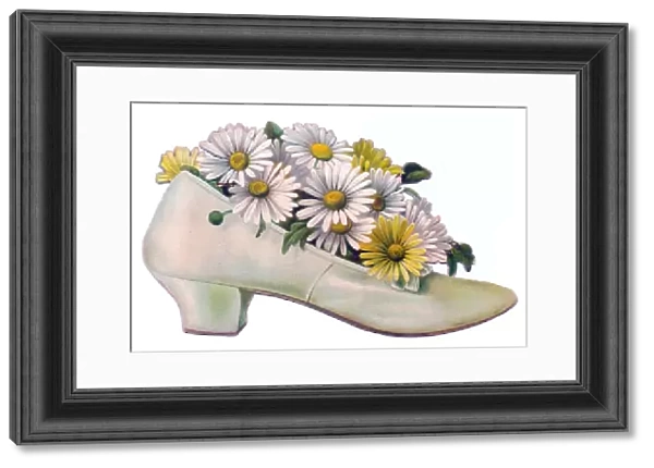 White and yellow daisies in a shoe-shaped greetings card