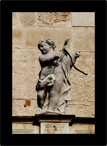 Cupid with bow and arrows. Sculpture. Facade of the Duomo in
