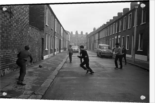 Boys playing football in a street, Belfast, Northern Ireland