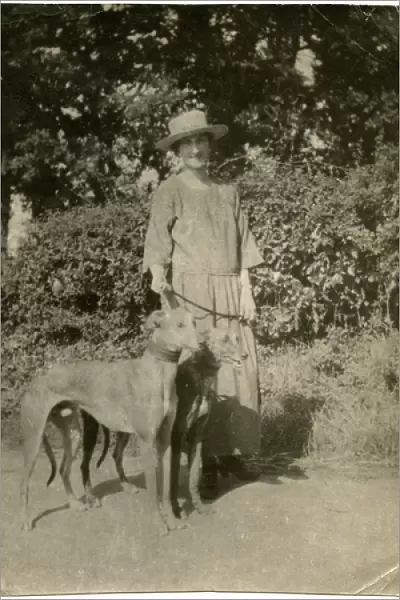 Woman with two dogs on a country lane