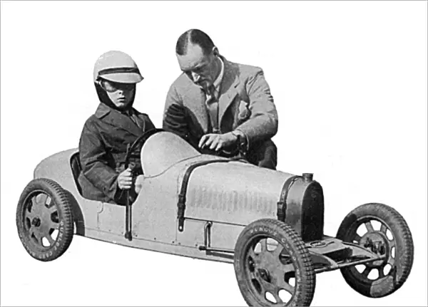 Sir Malcolm Campbell & Donald Campbell in toy motor car