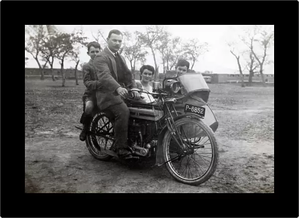 Man & family on 1915 Triumph motorcycle