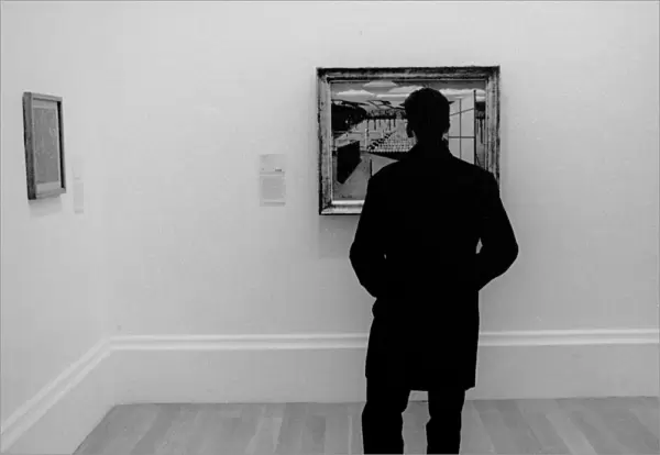 Man looking at a painting in an art gallery
