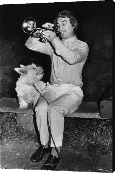 Man playing trumpet, dog listening