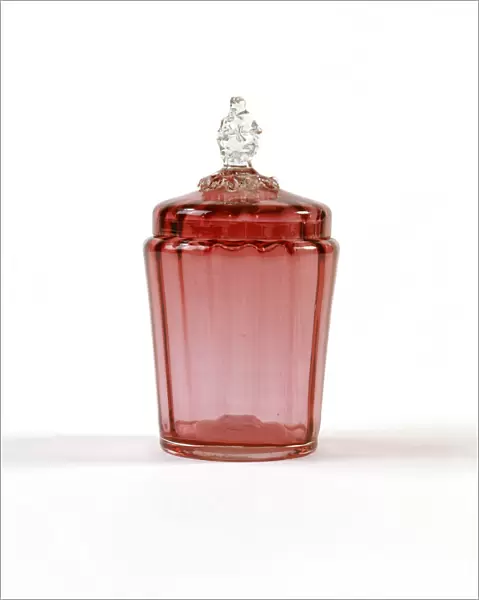 Jar. Cranberry-coloured glass jar with a ribbed interior