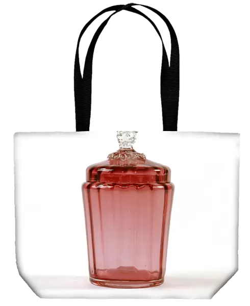 Jar. Cranberry-coloured glass jar with a ribbed interior