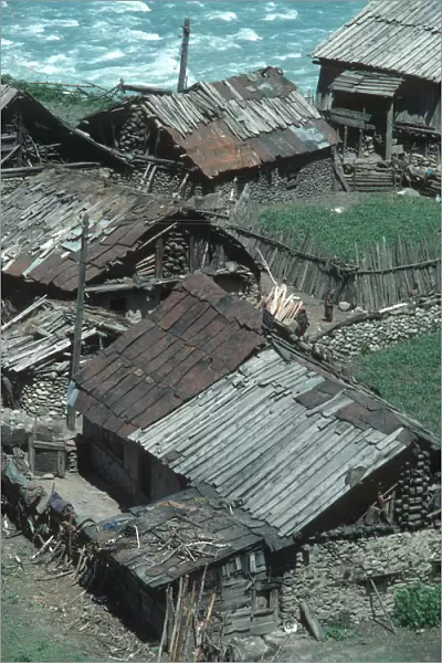 Ramshackle wooden houses alongside the river in Sind Valley