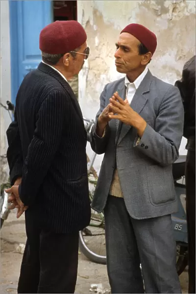 Two men talk in the street in Houmt Souk, Djerba, Tunisia