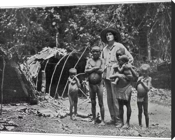 Lady Broughton, travelling in southern Africa, poses with a family of pygmies