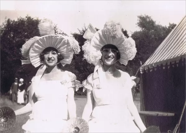 A candid portrait of the Dolly Sisters at a garden party c