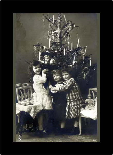 Three young Italian sisters by their Christmas Tree