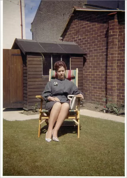Smart young lady - suburban garden - comfy garden chair