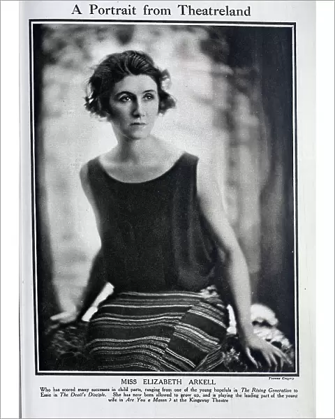 Elizabeth Arkell, (1891?-1962) actress, seated studio portrait. Captioned, A Portrait from Theatreland'. With description, Who has scored many successes in child parts
