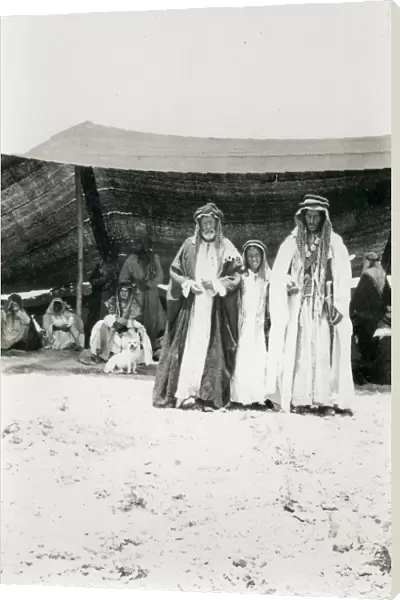 Two Bedouin men and a boy outside a tent, Middle East