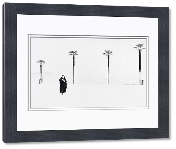 Nun with background of four palm trees