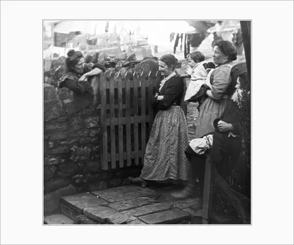 Women chatting in a back yard, Pontypool, South Wales