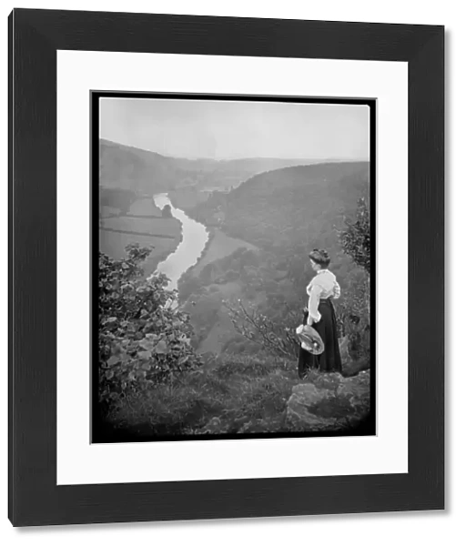 Woman looking down into a valley