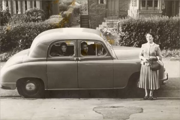 Family of three with their Singer car