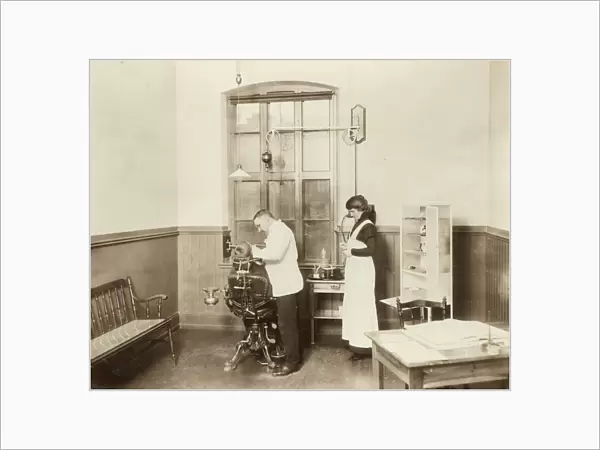 Dentist. A dentist and his nurse give a schoolboy his treatment, 1910 Date: c. 1910