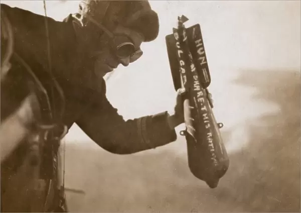 British airman dropping a bomb by hand, WW1