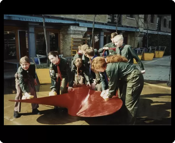 Scouts cleaning propeller near Tower Bridge, London