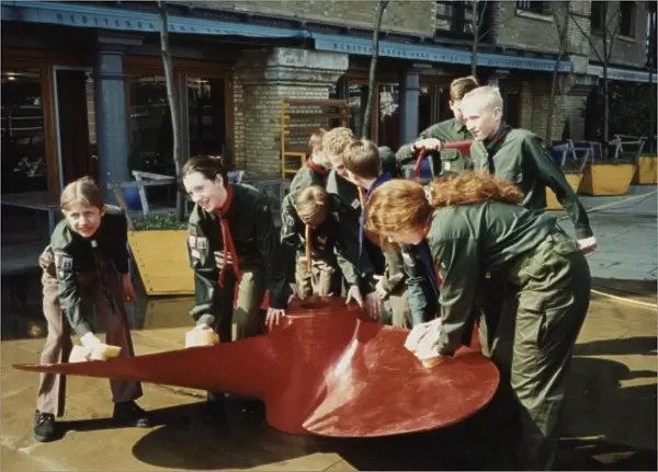 Scouts cleaning propeller near Tower Bridge, London