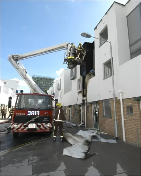 A hydraulic lift vehicle at the scene of a fire
