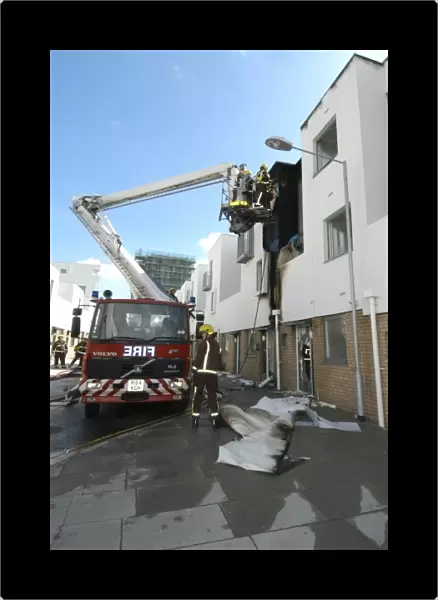 A hydraulic lift vehicle at the scene of a fire