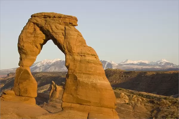 USA - Delicate Arch probably is the most famous sandstone rock sculpture in the Arches National Park. In the background the snow-capped La Sal Mountains. Photographed in spring (April). Arches National Park, Utah, USA