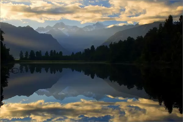 Lake Matheson - perfect reflection of Mount Cook and the Southern Alps in Lake Matheson at sunrise Westland National Park, West Coast, South Island, New Zealand