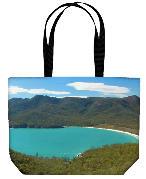 Wineglass Bay - beautiful, turquoise coloured Wineglass Bay and surrounding mountains seen from Wineglass Bay Lookout. This is one of the most famous natural landmarks on Tasmania - Freycinet National Park, Tasmania, Australia
