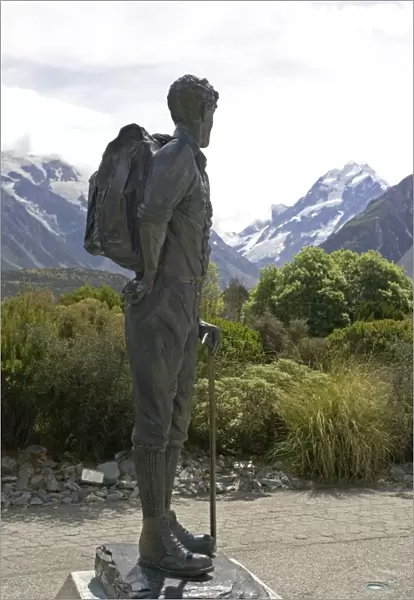 Bronze statue of Sir Edmund Hillary against snow capped mountains and forested slopes in Aoraki Mount Cook National Park. This spectacular wilderness area in South Island New Zealand has now been designated a World Heritage Site