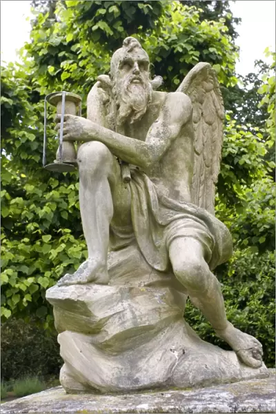 Stone statue of old Father Time Sandringham gardens near Kings Lynn Norfolk UK