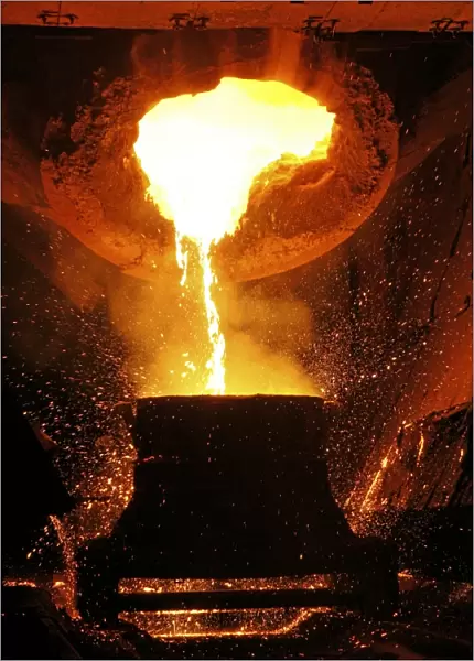Molten metal being poured from a vat