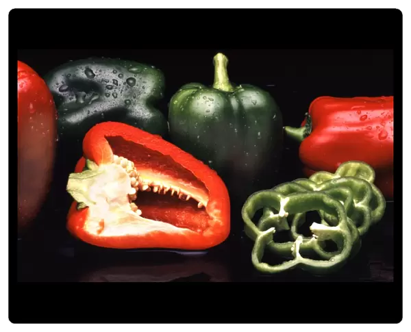 Peppers. Sliced and whole red and green peppers, or capsicums (Capsicum sp.)