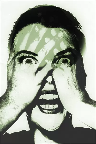 Fear. Conceptual artwork of a screaming woman seeing through her hands