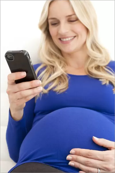 Pregnant woman using a mobile phone