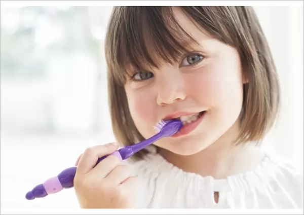 Toddler brushing her teeth