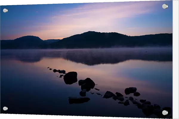 England, Cumbria, Lake District National Park. Dawn at Low Wray, looking across the still waters of Windermere, the largest lake to be found