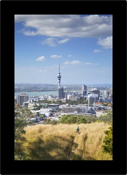 View of Auckland with man hiking on Mount Eden, Auckland, North Island, New Zealand, Pacific