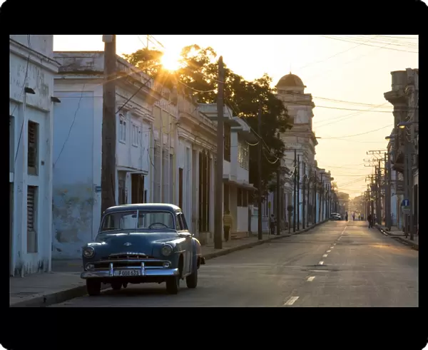 Street scene at sunrise with vintage American car, Cienfuegos, UNESCO World Heritage Site, Cuba, West Indies, Caribbean, Central America