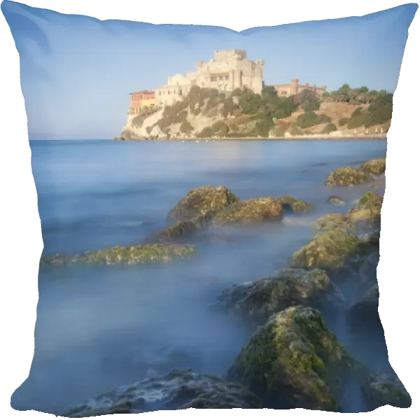 Alongside a picturesque millstone, atop a rocky promontory dominating the sea, rises the Castello di Falconara, Sicily, Italy, Mediterranean, Europe