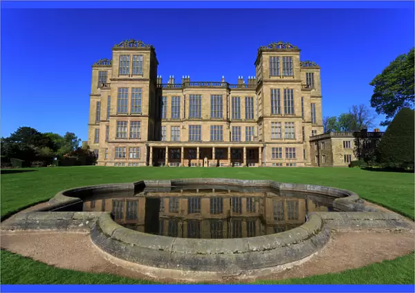 Hardwick Hall, near Chesterfield, reflected in pond under a clear blue sky, Derbyshire
